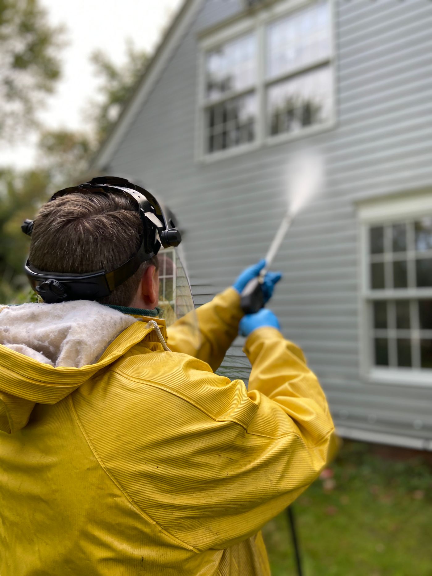 PK Construction Cleaning technician performing soft washing